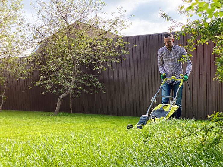Professional yard maintenance service mowing a lush lawn in St. Paul, Alberta